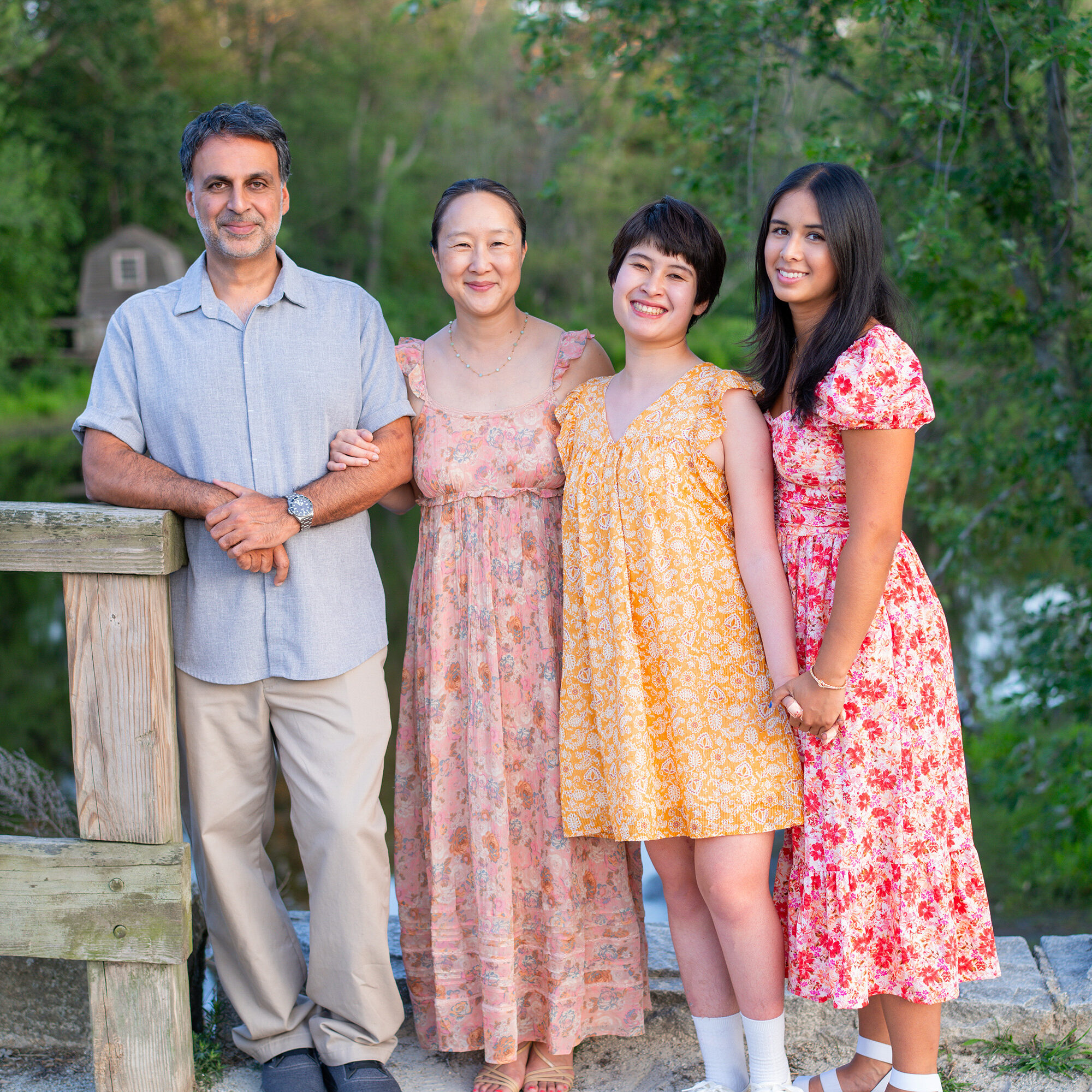 Family Portraits at the North Bridge in Concord, MA in the summer. Photographed by Chiha Portraits.