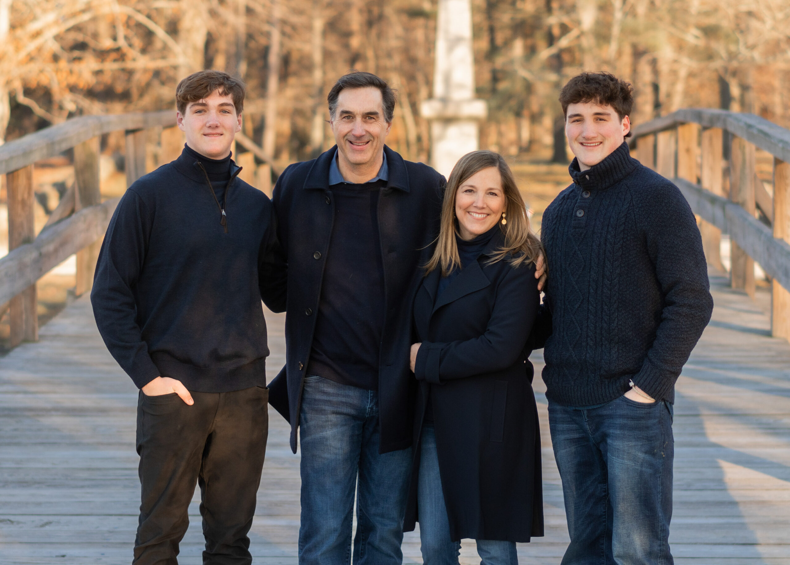 Family portrait outfit ideas for the fall and winter. Photographed at the North Bridge in Concord, MA in the winter. Photographed by Chiha Portraits.