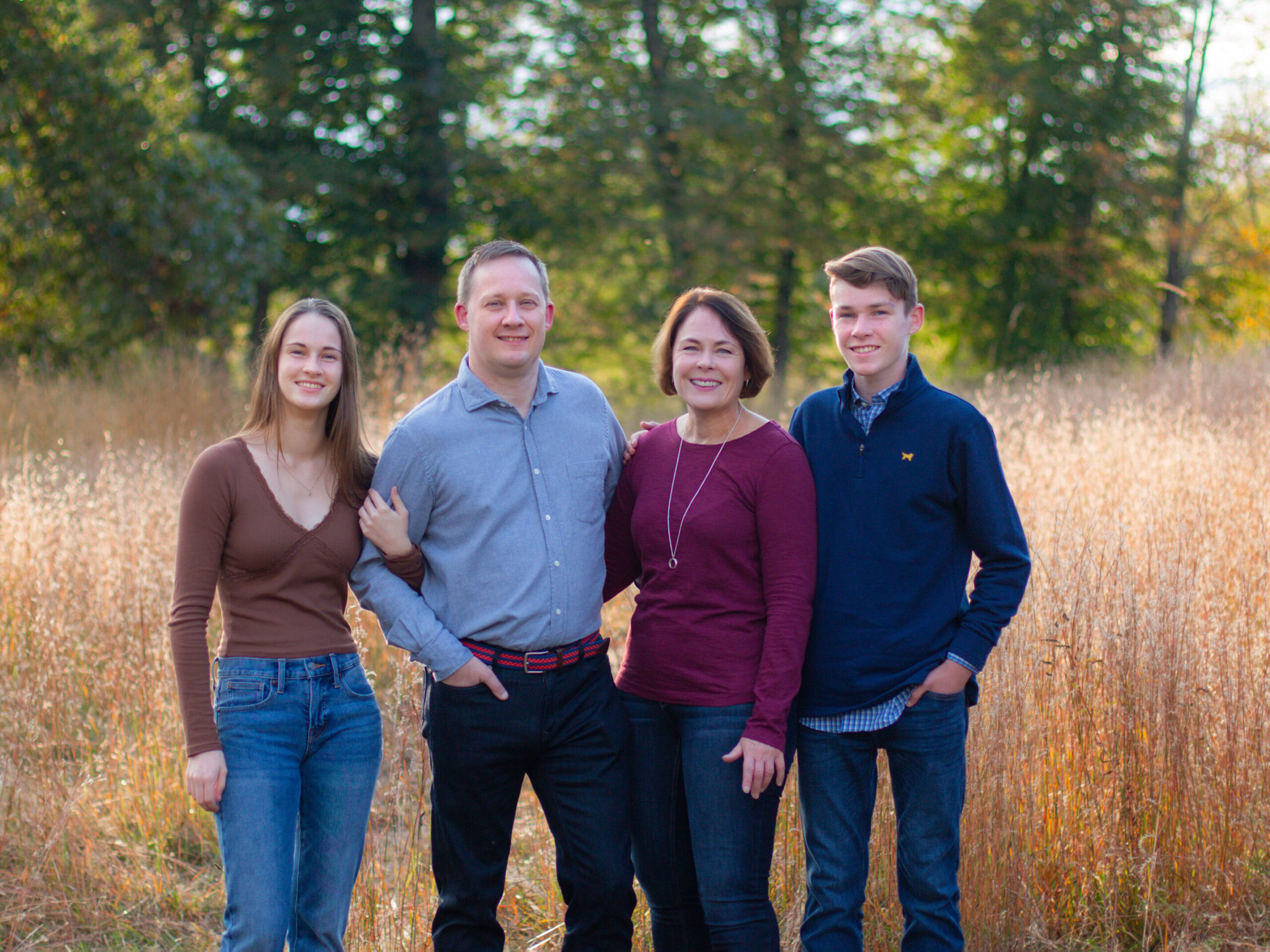 Family Portraits at the North Bridge in Concord, MA in the fall. Photographed by Chiha Portraits.