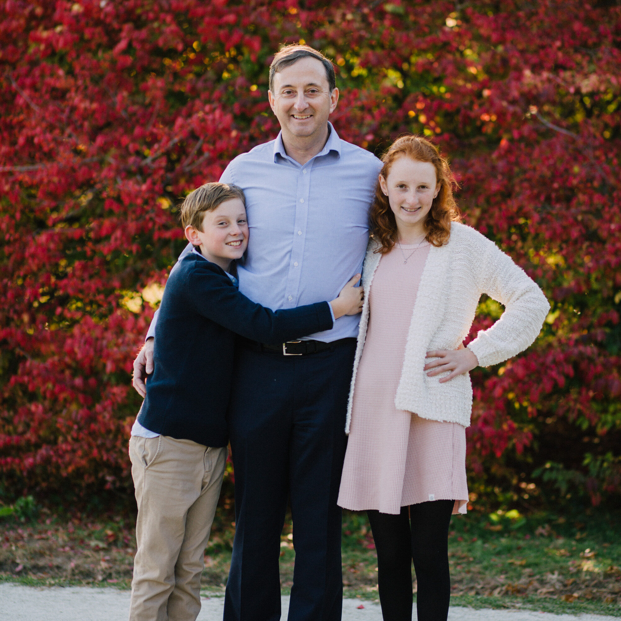 Family Portraits at the North Bridge in Concord, MA in the fall. Photographed by Chiha Portraits.