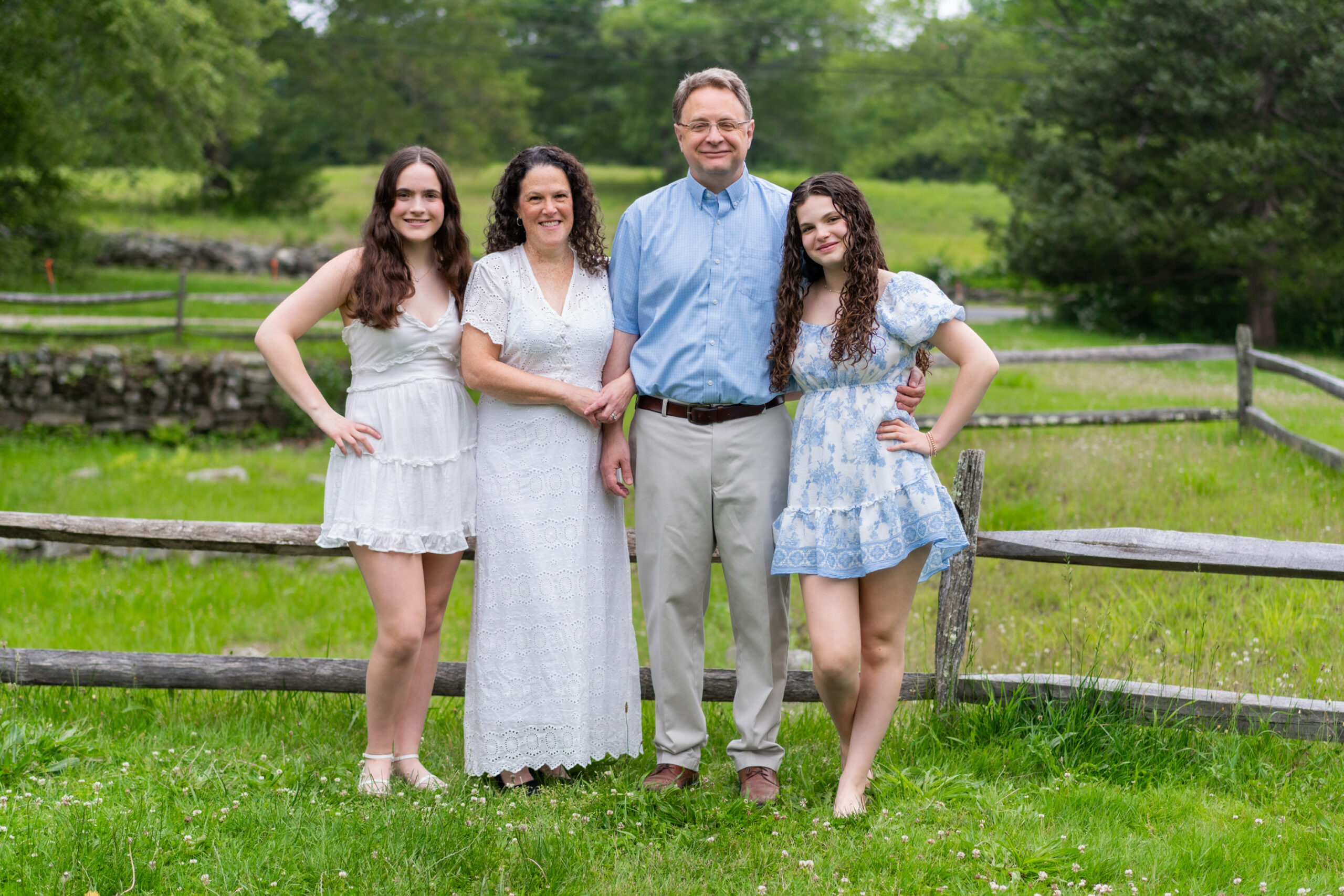 Family portrait outfit ideas for spring and summer. Photographed at the North Bridge in Concord, MA in the spring. Photographed by Chiha Portraits.